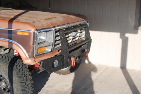 1982 Ford Bronco - Front view of a brown truck an aftermarket bumper and winch. The grille displays the Ford logo.