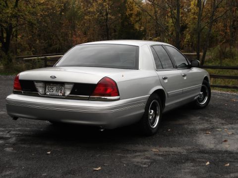 2000 Ford Crown Victoria - Rear view of a silver 2000 Ford Crown Victoria parked outdoors.