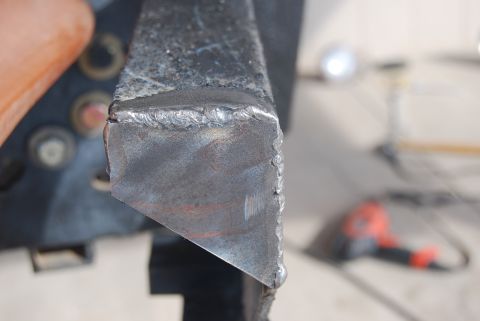 1982 Ford Bronco - Close-up of a rough, welded metal bracket, likely a vehicle part.