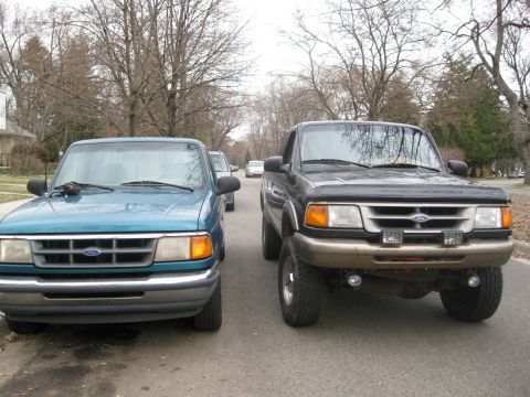 1995 Ford Ranger - Two 1995 Ford Ranger trucks are parked on a street, one teal and one dark gray.