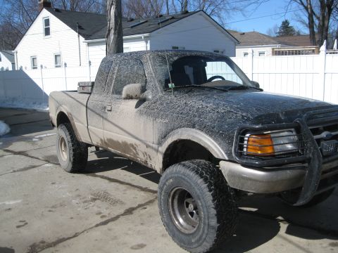 1995 Ford Ranger - This mud-splattered Ford Ranger pickup truck is viewed from the front three-quarter angle.