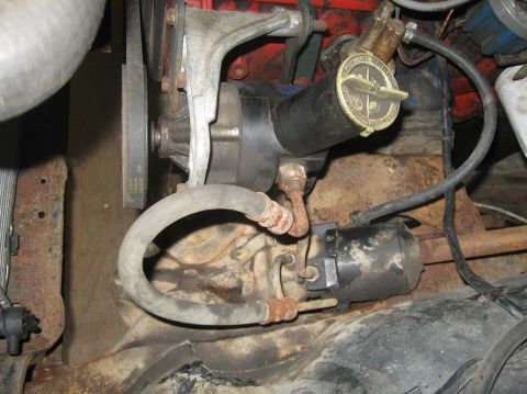 1981 Ford Bronco - Close-up view of an engine component with visible hoses and a belt.