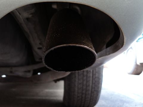 2001 Mercury Grand Marquis - Close-up view of a vehicle's exhaust pipe and a portion of its tire.