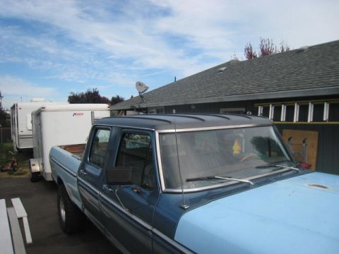 1976 Ford F-250 - This 1976 Ford F-250 crew cab is seen towing a white trailer under a partly cloudy sky.