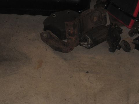 1979 Ford Bronco - Collection of aged and rusty suspension components laid out on a concrete surface.