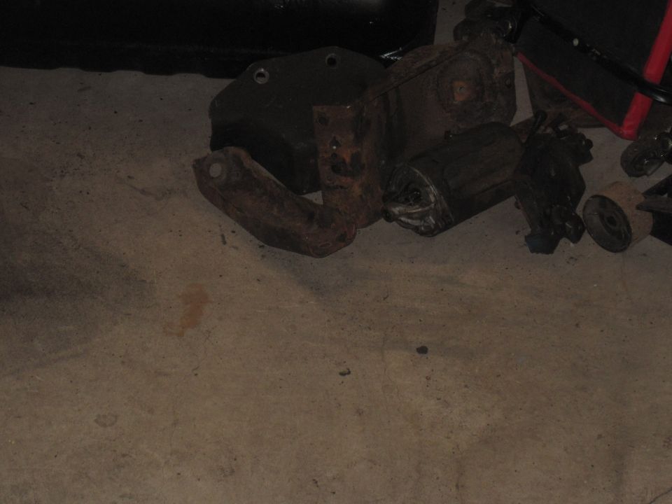 Various rusty suspension parts on concrete floor