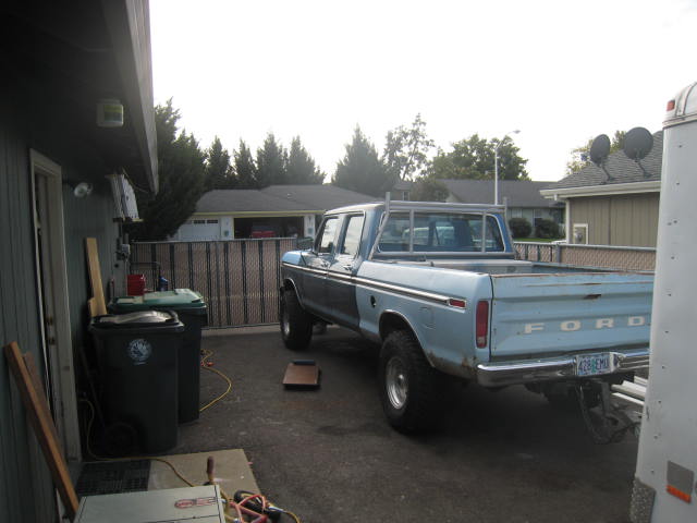 1976 Ford F-250 pickup truck, light blue with a two-tone stripe, parked in a driveway