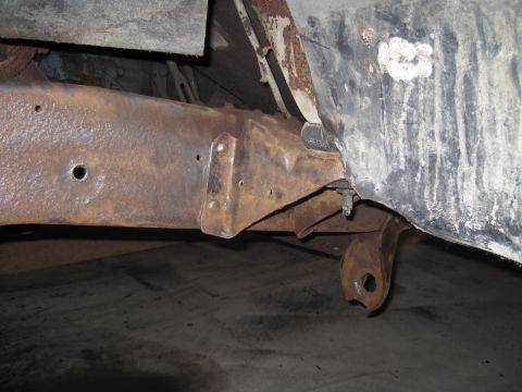 1979 Ford Bronco - Close-up of heavily rusted vehicle frame and suspension components, showing significant corrosion.