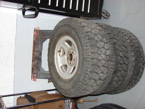 1993 Jeep YJ - Spare tires are stored on a rack, ready for use.