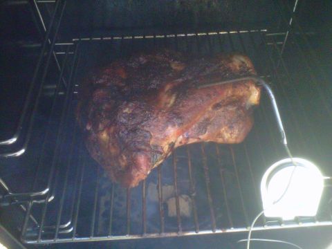 1986 Ford Bronco - A large piece of meat is being smoked, with a thermometer monitoring its internal temperature.