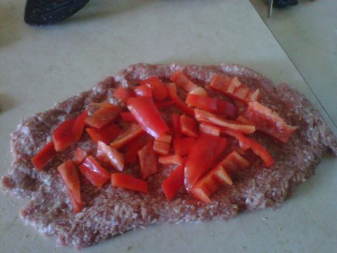 1986 Ford Bronco - A close-up view of ground meat being prepared with chopped red bell peppers, with a Supermotors.net watermark visible.