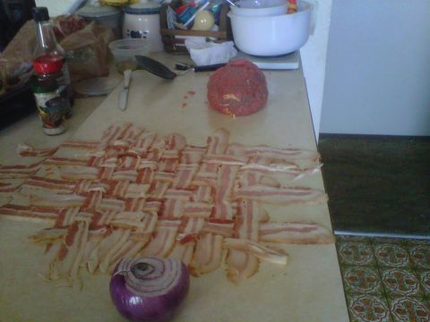 1986 Ford Bronco - A woven bacon mat and a red onion are prepared on a kitchen counter.