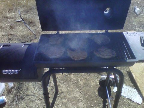 1986 Ford Bronco - Burgers cook on a grill, sending smoke into the air.