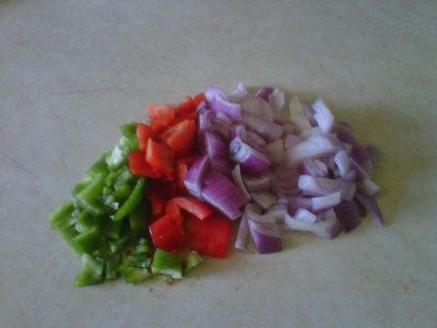 1986 Ford Bronco - Chopped vegetables including green pepper, red pepper, and red onion are piled on a surface.