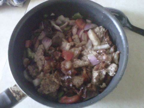 1986 Ford Bronco - A pot of food containing meat, onions, and peppers is shown.