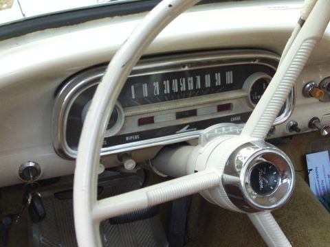 1963 Ford Ranchero - The interior of a 1963 Ford Ranchero, a white steering wheel and a dashboard with prominent gauges and the "Ranchero" emblem.