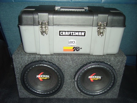 1995 Ford Bronco - A Craftsman toolbox rests on a pair of Kicker subwoofers, likely installed in a vehicle's interior.
