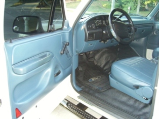 1995 Ford Bronco - Interior view of a 1995 Ford Bronco, highlighting the driver's side door and dashboard.