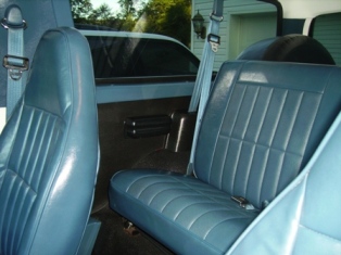 1995 Ford Bronco - Interior view of a light blue SUV, showing the seats and dashboard details.