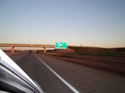 1989 Ford Taurus - Driving on a highway towards a welcome to Texas sign under a clear sky.