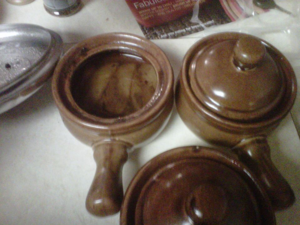 three brown crock pots with lids, one pot is open showing inside