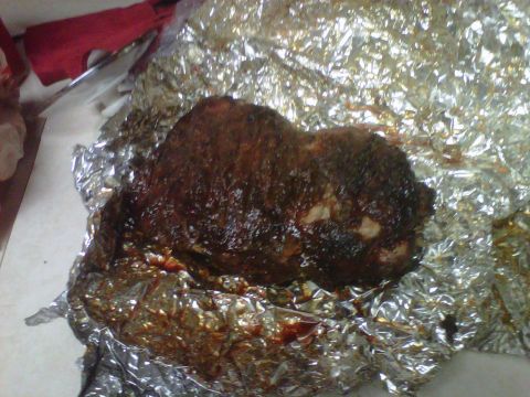 1986 Ford Bronco - This image shows a piece of smoked food wrapped in aluminum foil, with a watermark for Supermotors.net at the bottom right.
