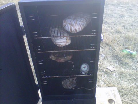 1986 Ford Bronco - Smoker cabinet filled with food, including items wrapped in bacon, and a thermometer.