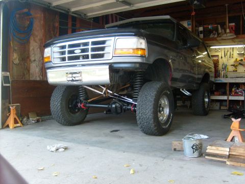 1986 Ford Bronco - This lifted SUV features a custom suspension and front axle, with "SUPERMOTORS.NET" visible on the floor.