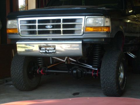 1986 Ford Bronco - This lifted Ford truck features a chrome grille and a custom license plate with a bold message.