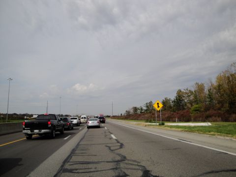 1989 Ford Taurus - A cloudy day on the highway with several vehicles in traffic.
