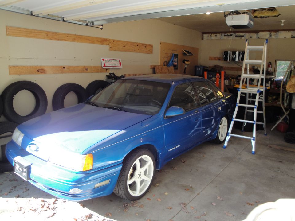 Blue 1989 Ford Taurus sedan parked in garage