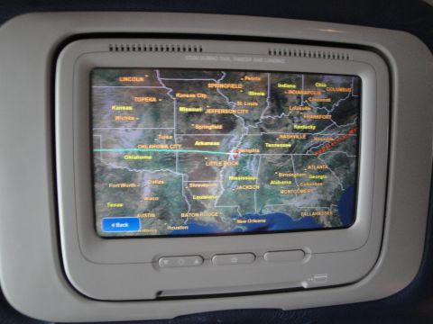 1989 Ford Taurus - An in-flight entertainment screen displays a map of the central United States, indicating a flight path.