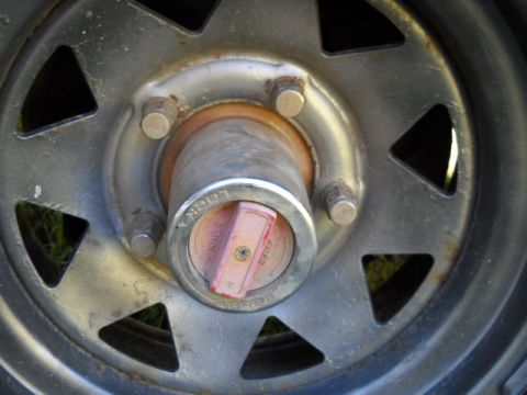 1993 Ford F-150 - A close-up view of a vehicle's wheel hub, a red and silver locking mechanism with visible 'LOCK' and 'FREE' indicators.
