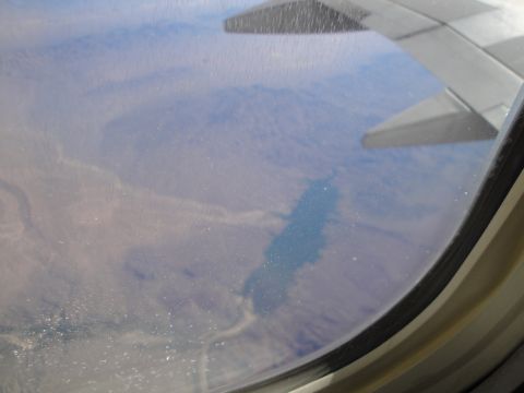 1989 Ford Taurus - A landscape viewed from an airplane window, with the wing visible in the foreground.