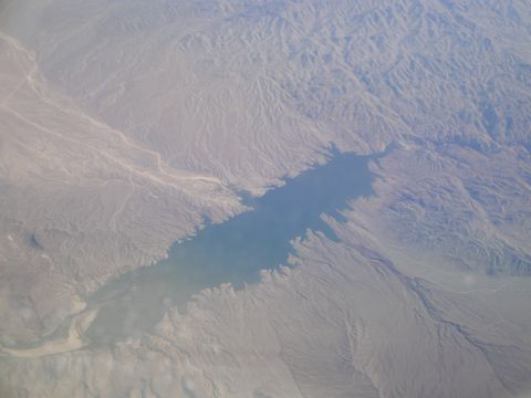 1989 Ford Taurus - An aerial perspective captures a lake within , arid mountains, showing the vastness of the landscape.