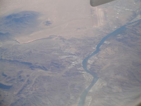 1989 Ford Taurus - An aerial perspective captures a river flowing through a valley, with a settlement visible along its course.