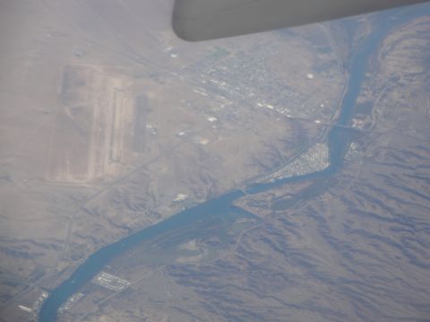 1989 Ford Taurus - An aerial perspective captures a river flowing through a landscape, with an airport and a small town visible.