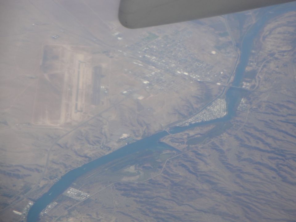 Aerial view of a river, an airport, and a town