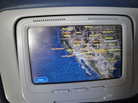 1989 Ford Taurus - An in-flight entertainment screen shows a map of the western US, with a flight path indicated.