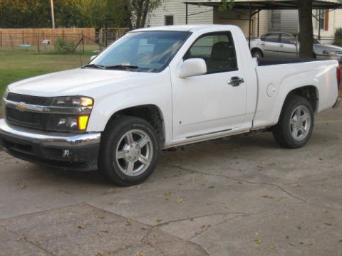 1996 Ford Thunderbird - A white pickup truck is parked on a concrete driveway with another car in the background.