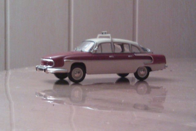 Model car taxi with two-tone paint and a rooftop sign