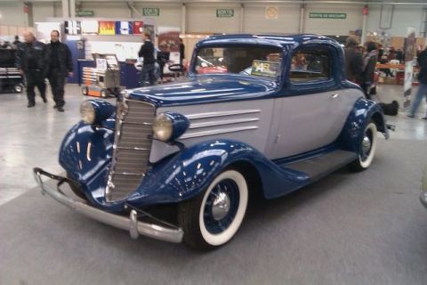1991 Ford LTD Crown Victoria - A two-tone blue and gray coupe from the mid-1930s is displayed indoors.