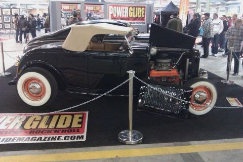 1991 Ford LTD Crown Victoria - A black hot rod convertible is displayed with its hood open, revealing the engine.