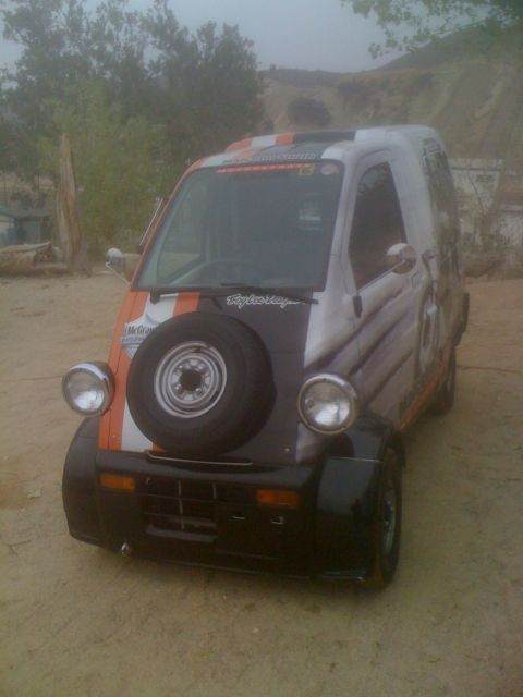 1968 Ford Mustang - This custom microvan features a spare tire on its front and a distinctive racing livery.