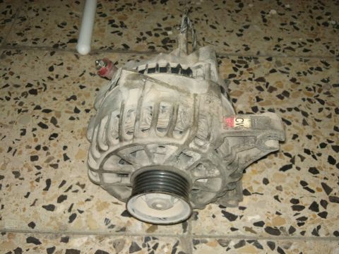 1998 Ford Crown Victoria - A used alternator is shown, likely removed from a vehicle for repair or replacement.