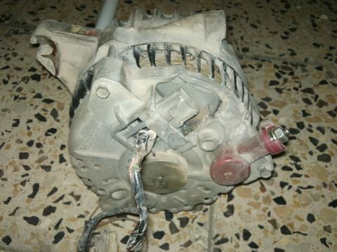 1998 Ford Crown Victoria - Close-up of a dusty Motorcraft alternator, likely a replacement part.