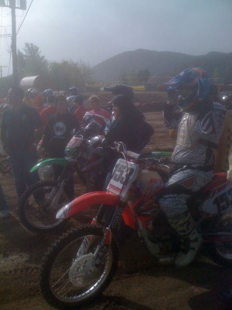 1968 Ford Mustang - A group of people and their dirt bikes are gathered on a dirt track, possibly before a race.