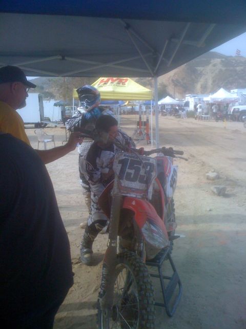 1968 Ford Mustang - A motocross motorcycle with the number 153 is visible at an event, with other tents and vehicles in the background.