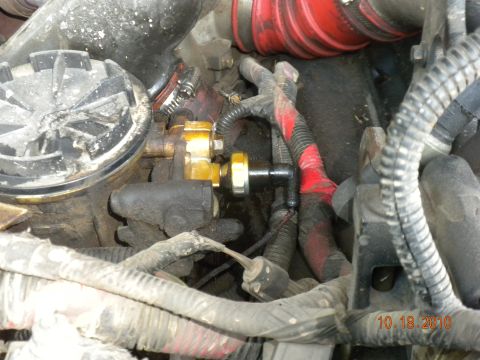 1989 Ford Bronco - Close-up view of engine components, including hoses and wiring, with a visible date stamp.