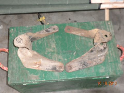 1989 Ford Bronco - Four rusty metal vehicle parts are displayed on a green wooden box, with a date stamp of 10.18.2010 visible.